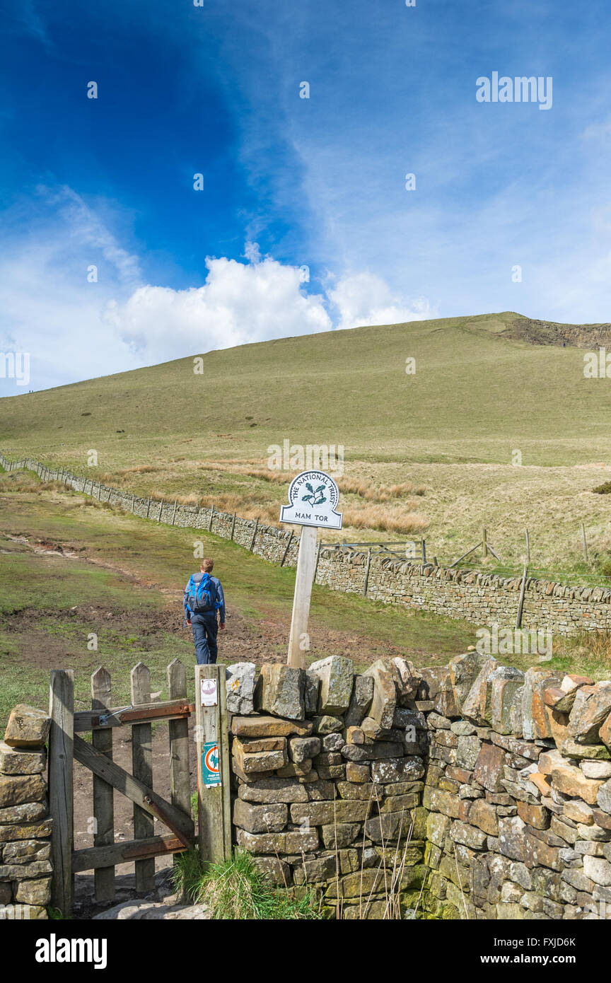Male walker ascending the footpath to Mam Tor from Windy Knoll in the Peak district, Derbyshire, England, U.K. Stock Photo