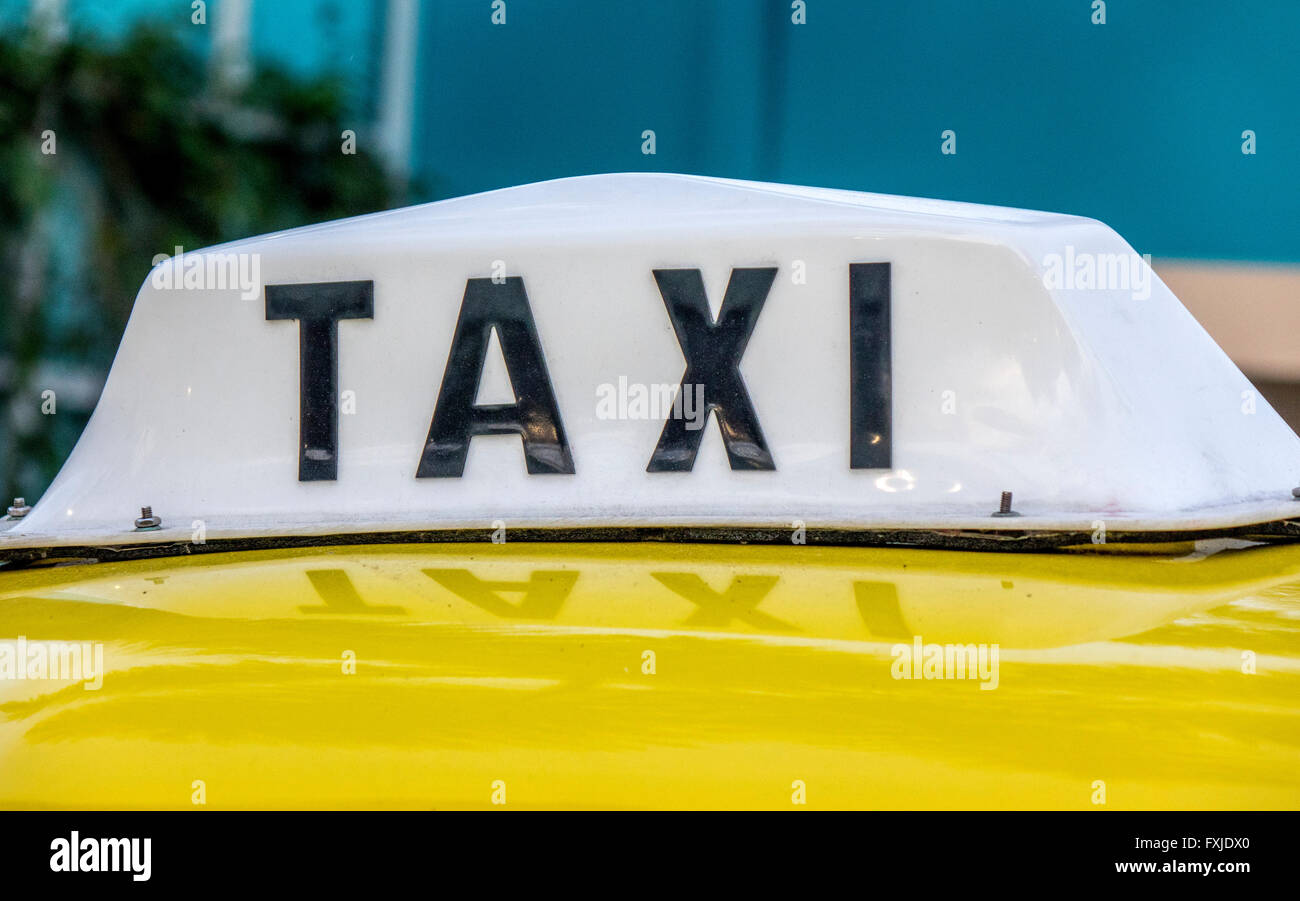 Roof Mounted Illuminated Taxi Sign On A Yellow Taxi Cab In The United