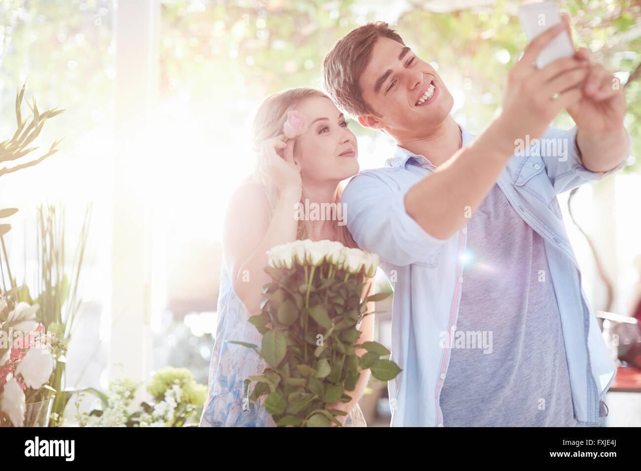 Couple taking selfie at flower shop Stock Photo