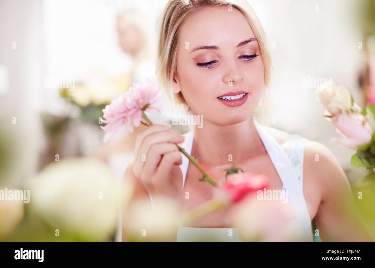 Close up of florist arranging bouquet Stock Photo