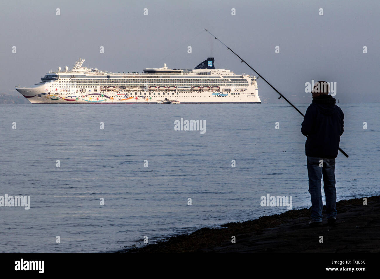 Luxury liner Seven Seas approaching Edinburgh with man fishing in