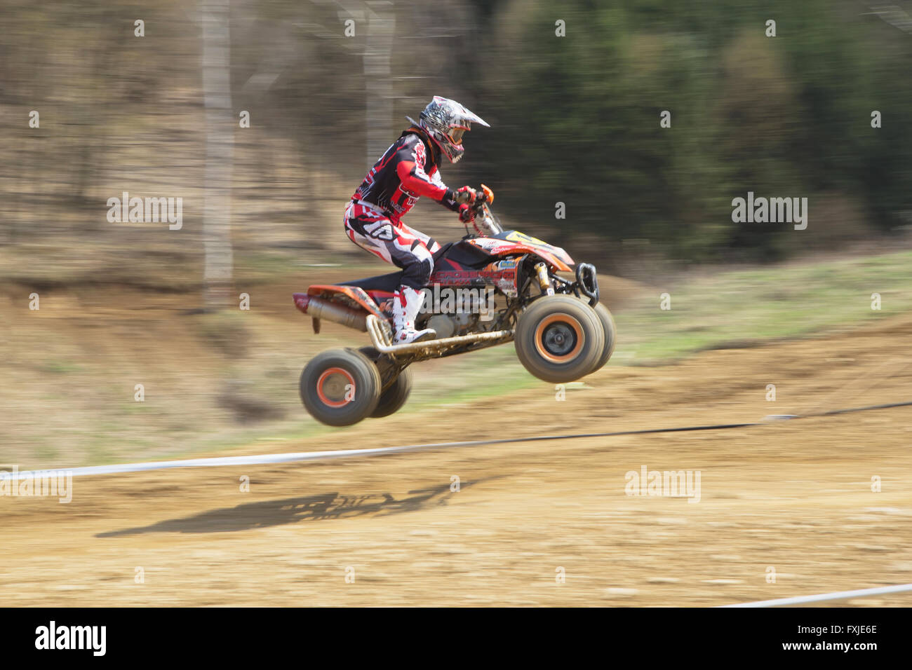 Dynamic shot of young racer jumping on a quad motorbike Stock Photo Alamy