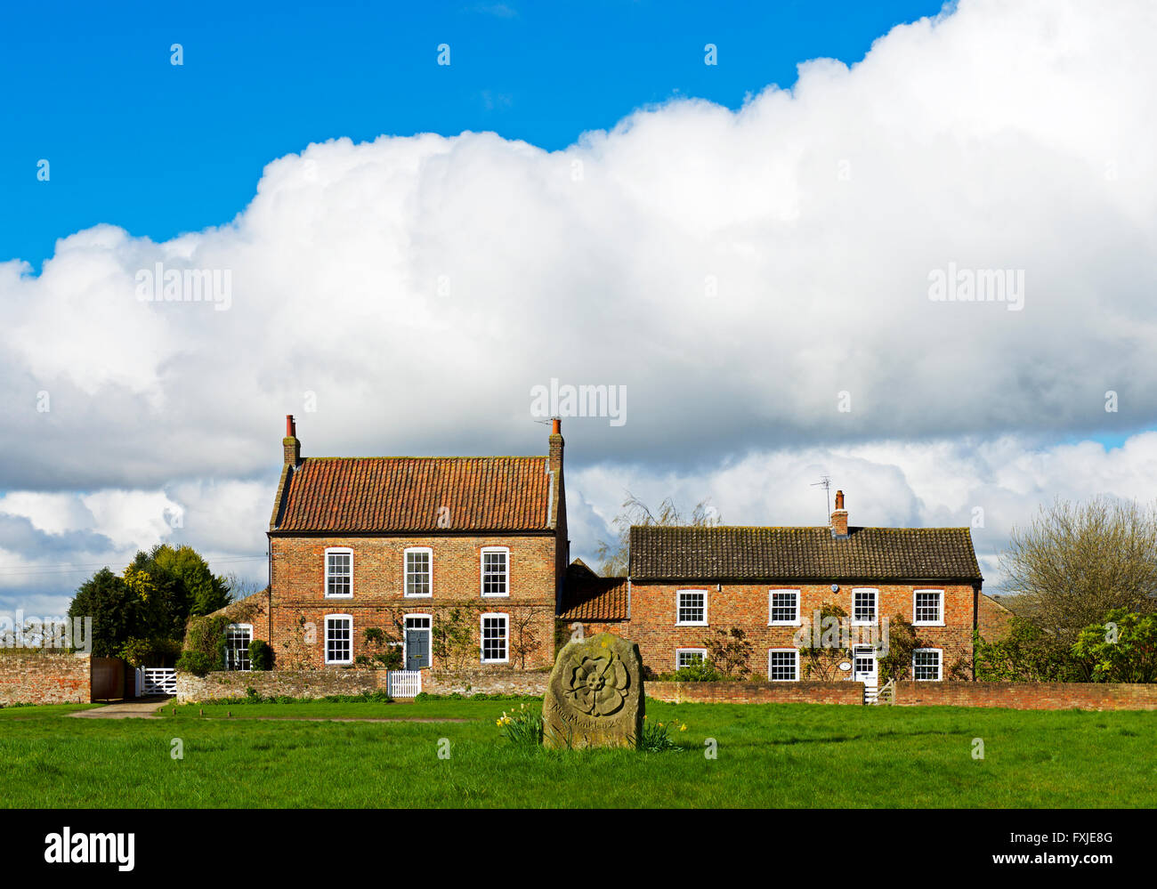 Cottage and millennial stone in the village of Nun Monkton, North