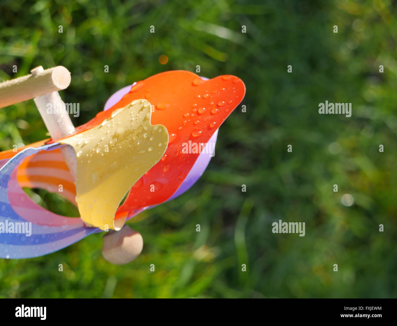 Toy windmill with morning due on it's sails Stock Photo