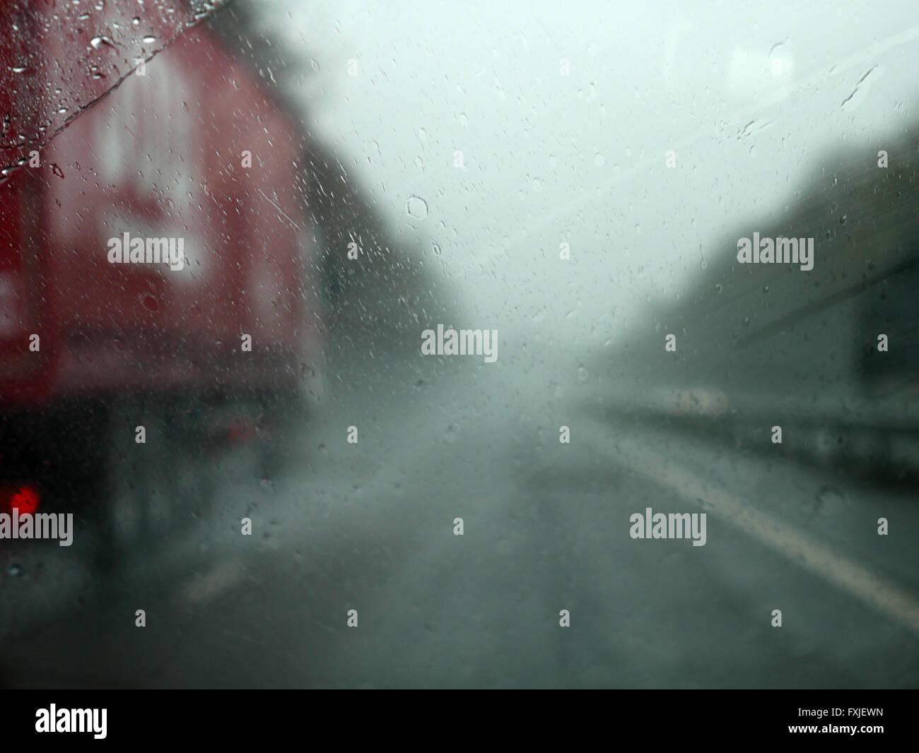 Rain soaked dual carriageway sees heavy good vehicle  transport good to its destination Stock Photo