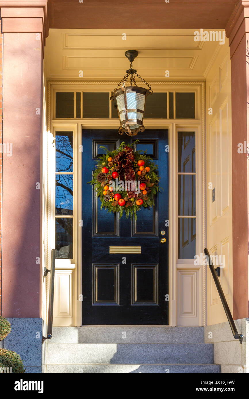 A Christmas wreath or garland  hanging on a front entrance door on a house in the Beacon Hill district of Boston, Boston,  Massachusetts, USA Stock Photo