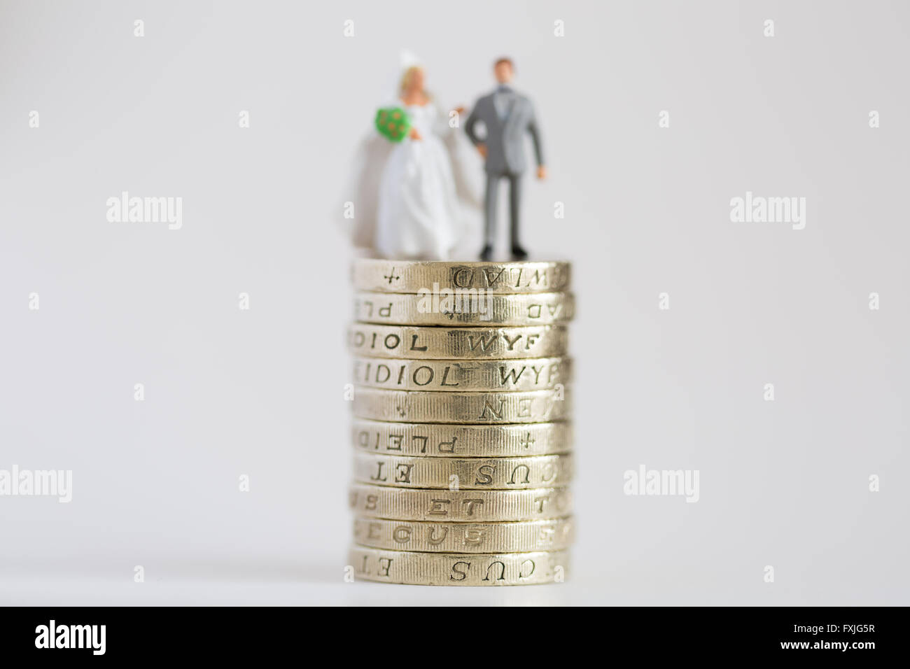 Close up/macro model stock photo depicting married husband and wife on £1 pound coin stack Stock Photo