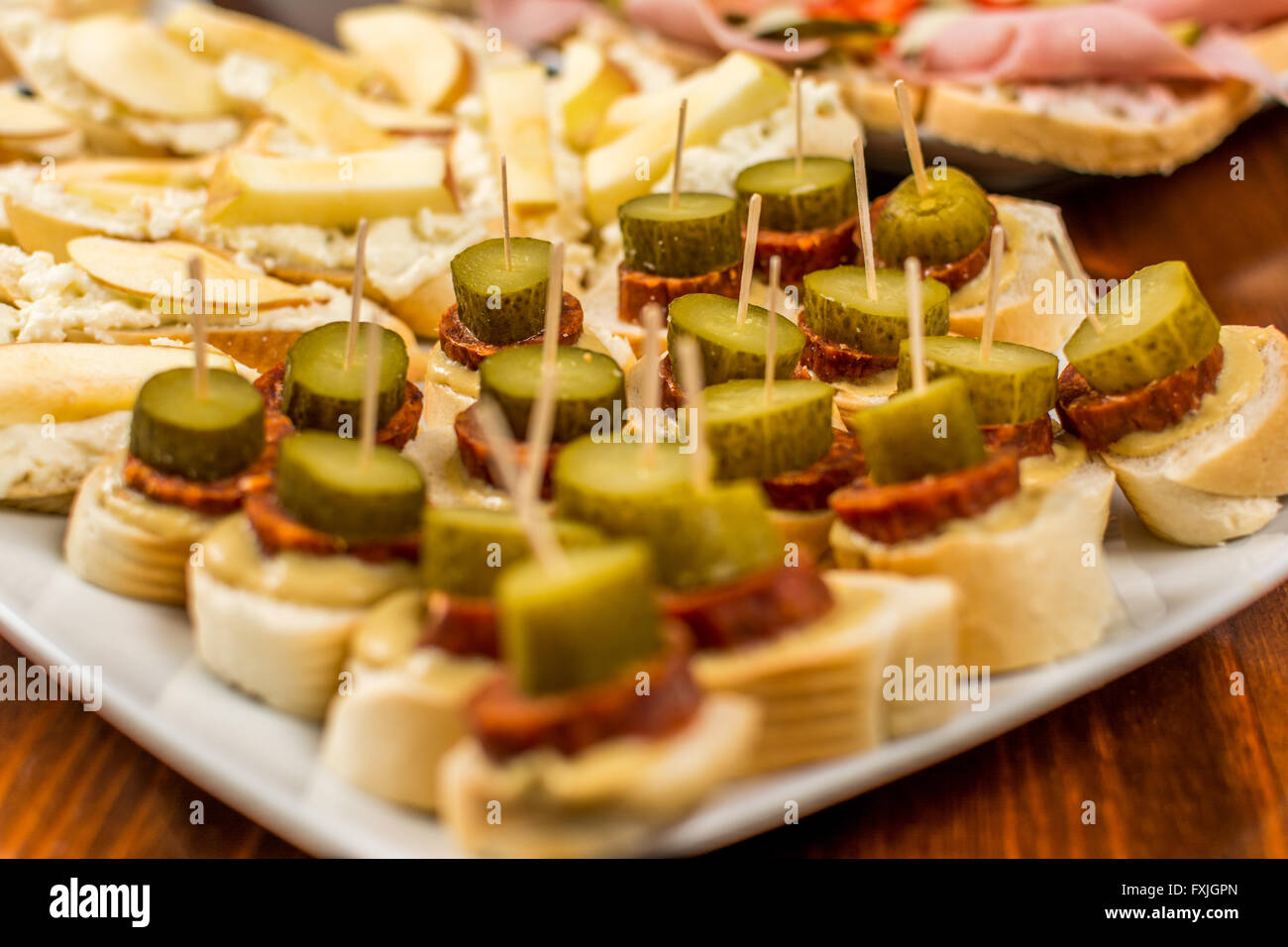 Canapes with sausage and gherkin wood table Stock Photo Alamy