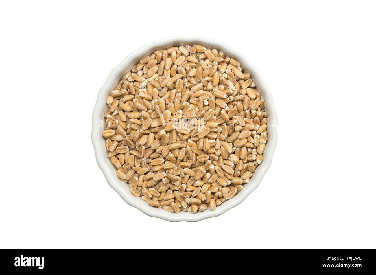 Decorticated spelt ina a ceramic pot on white background Stock Photo