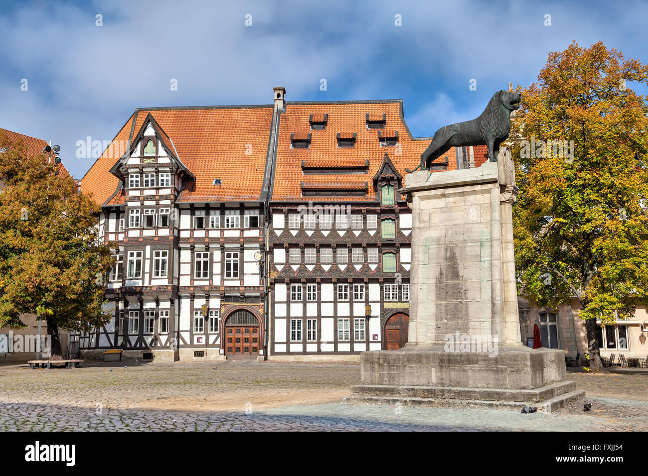 Old half-timbered building and statue of lion on Burgplatz square in Braunschweig, Germany Stock Photo