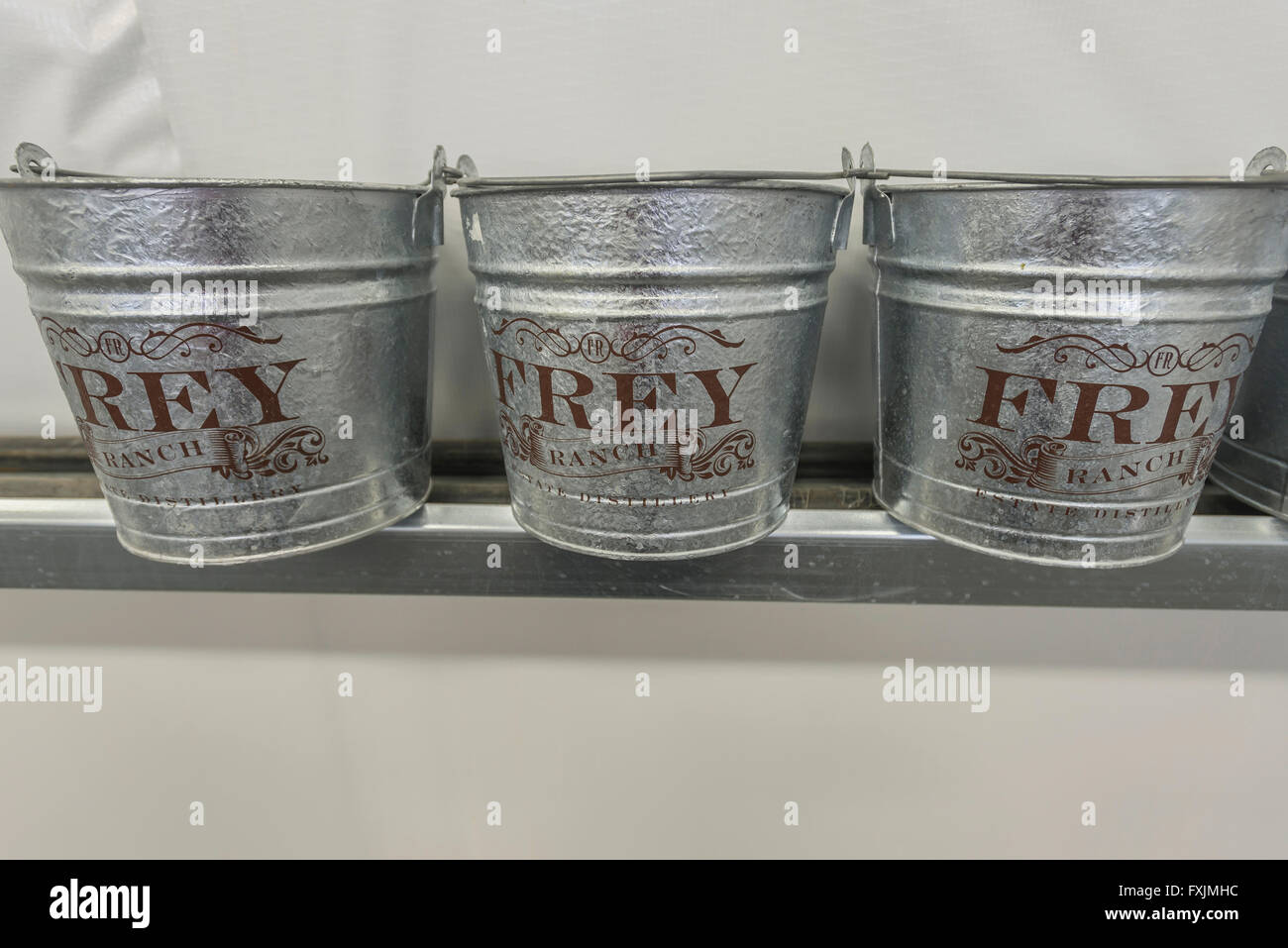 Three decorative tin buckets labeled Frey Ranch, at the Frey Distillery in Fallon, Nevada. Stock Photo