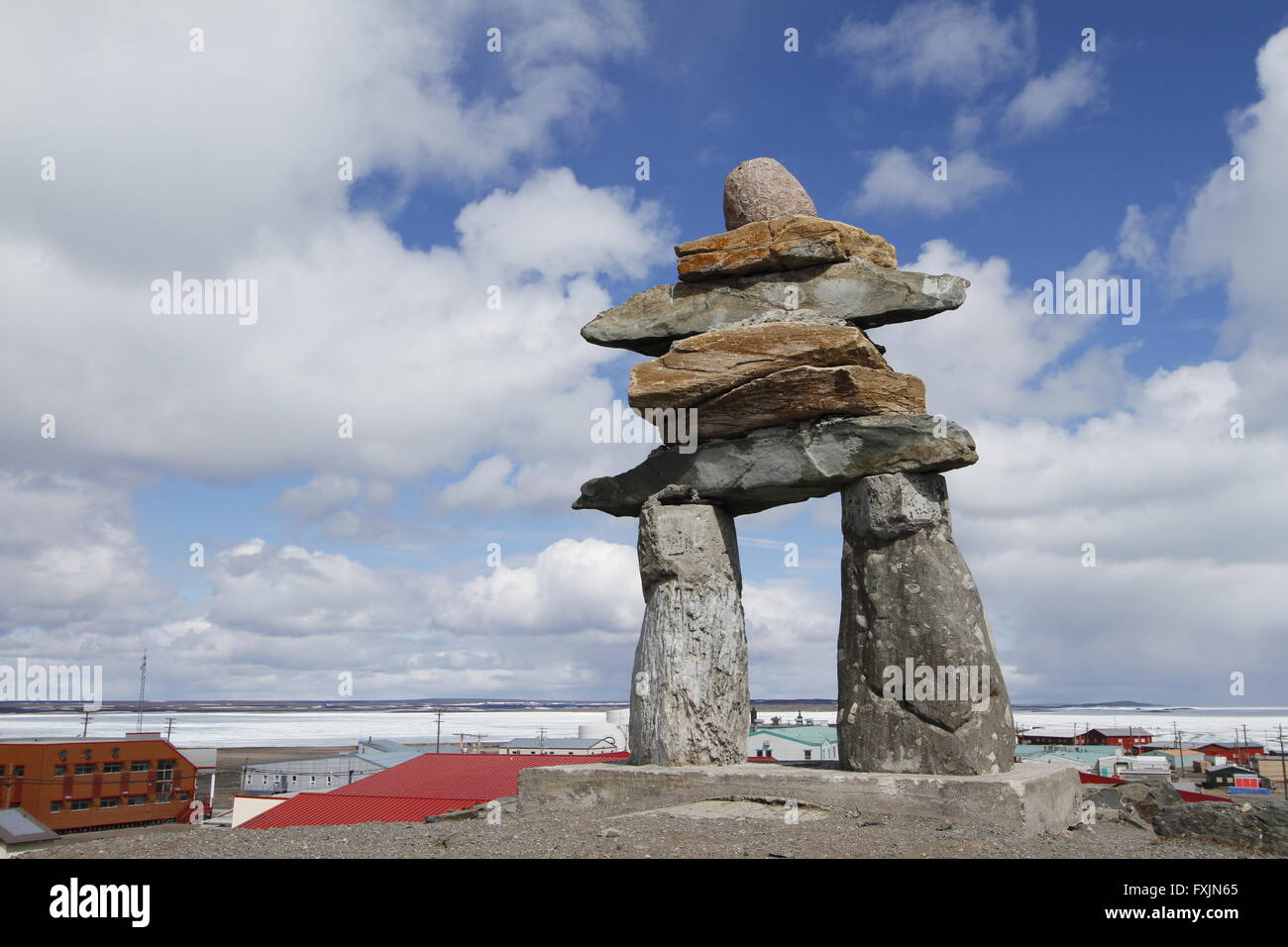 Inukshuk (or Inuksuk) at top of the hill in the community of Rankin Inlet, Nunavut near Hudson Bay, Canada Stock Photo