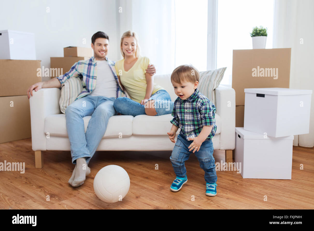 happy family moving to new home and playing ball Stock Photo - Alamy