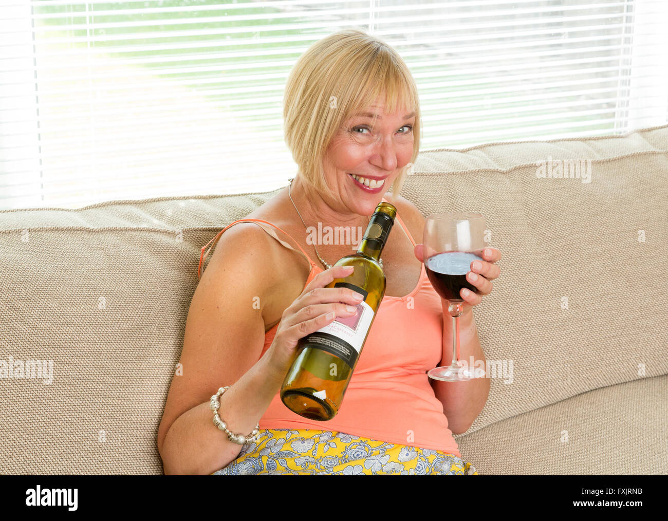 drunk woman drinking wine Stock Photo