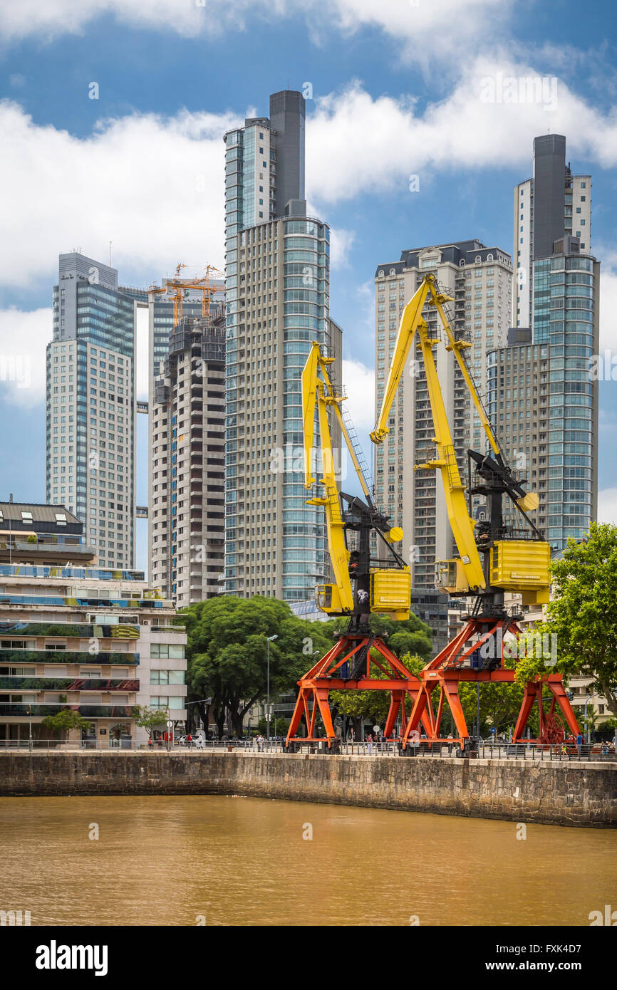 High-rise buildings and decommissioned cranes at the waterfront district of Puerto Madero, Buenos Aires, Argentina, SA Stock Photo