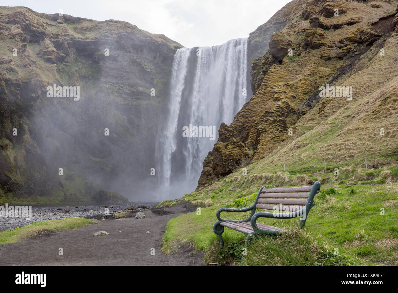 Skogafoss Waterfall, Southern Iceland, with bench seat Stock Photo