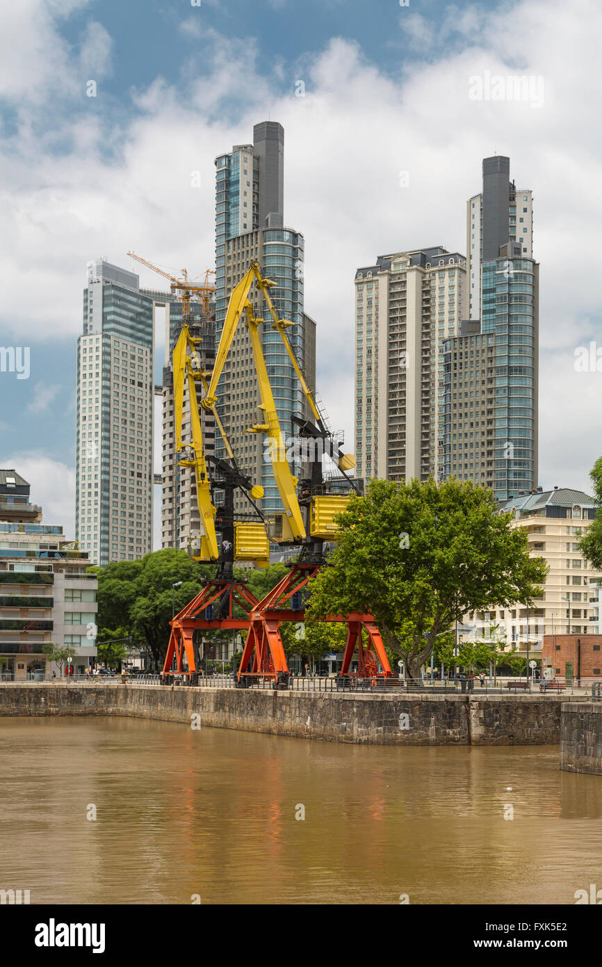 High-rise buildings and decommissioned cranes at the waterfront district of Puerto Madero, Buenos Aires, Argentina, SA Stock Photo