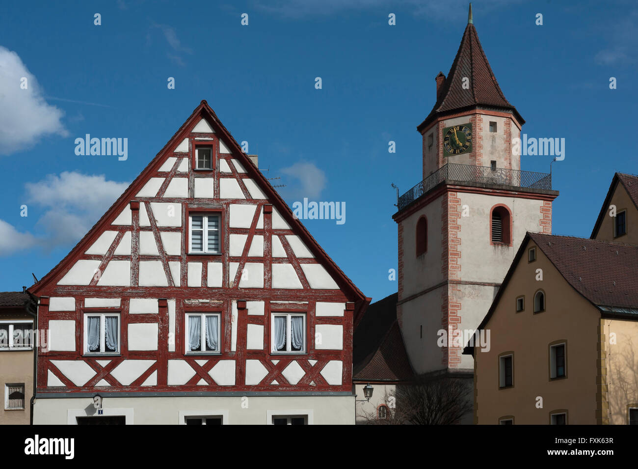 Romanesque tower of the Holy Trinity Church, left an old Franconian half-timbered house, Gräfenberg, Upper Franconia, Bavaria Stock Photo