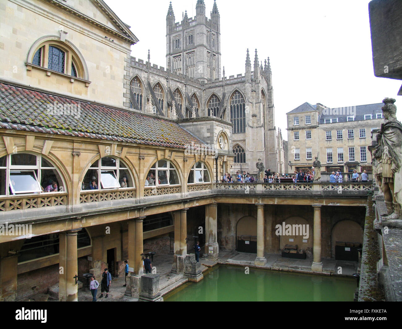 The Great Bath, part of the Roman Baths Complex in Bath, and Bath Abbey in the background Stock