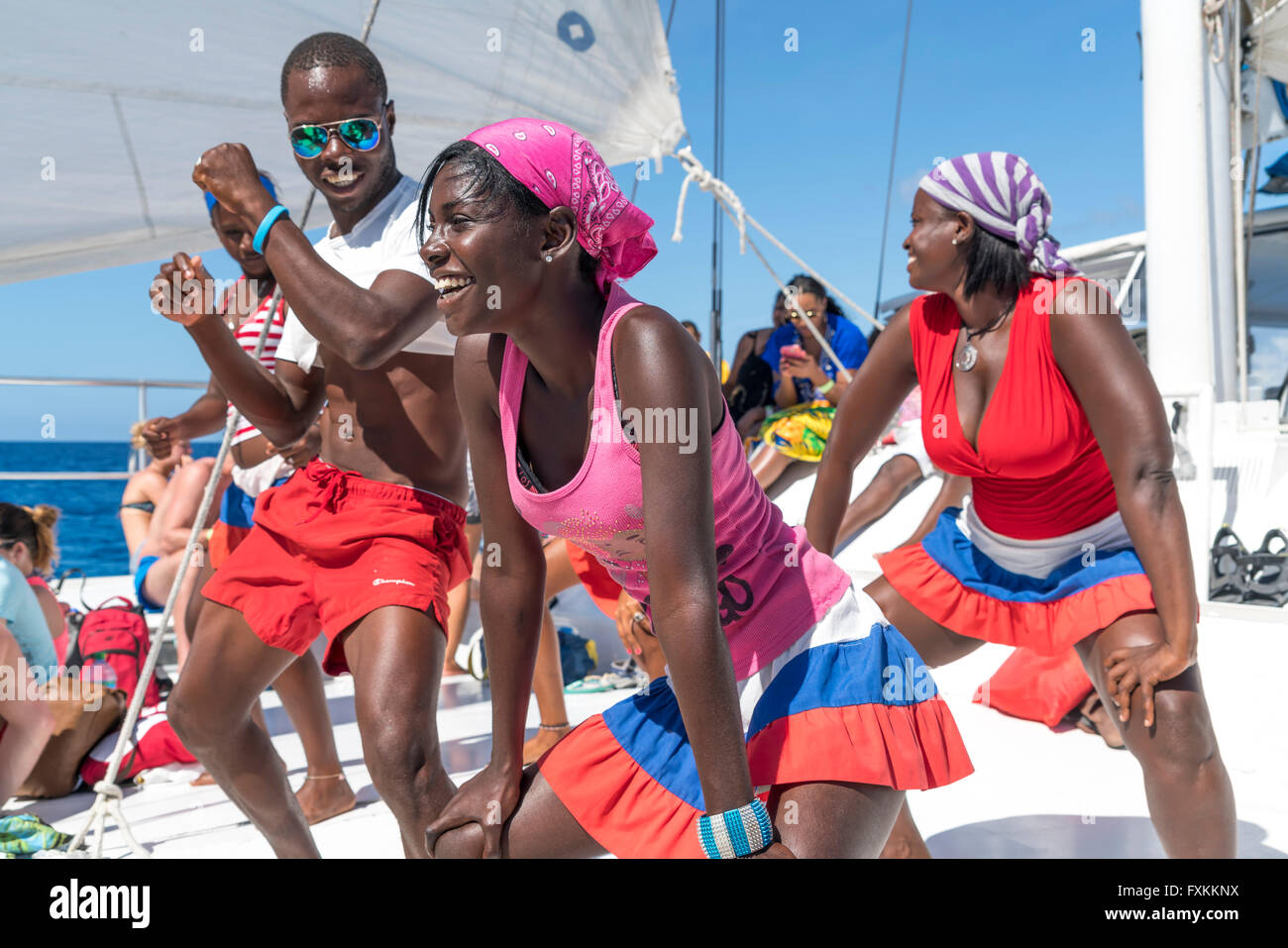 Tourists and entertainer dancing on a excursion catamaran to Isla Saona,   Parque Nacional del Este, Dominican Republic, Carribe Stock Photo