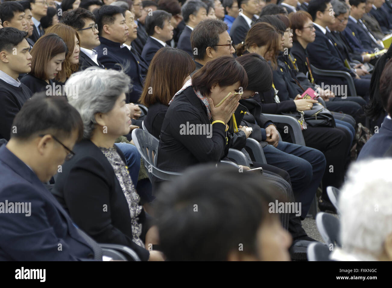 Ansan, Gyeonggi, South Korea. 16th Apr, 2016. A visitor and relative of a victim of the sunken ferry Sewol commemorate during a ceremony for the second anniversary of the sinking at a memorial altar in Ansan, South Korea. Thousands of South Koreans on Saturday participated in memorial events nationwide for the more than 300 people who died in a ferry disaster two years ago that deeply rattled the country. About 2,500 people, including grieving family members and victims, gathered for an event marking the second anniversary of the sinking at a memorial altar in Ansan, where most of the victi Stock Photo