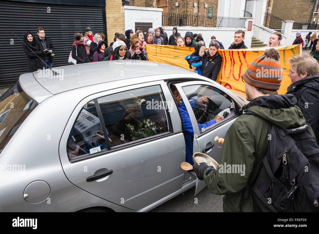 London, UK. 16th April, 2016. The driver of a car delivering items to St Francis of Assisi church in Stratford tries to force her way through a 'reproductive rights' protest by campaigners from feminist, anti-capitalist and LGBT groups outside the church. Campaigners were protesting against recent intimidation of women outside an abortion clinic by faith-based anti-abortionists and a proposed march by them from the church to the abortion clinic. Credit:  Mark Kerrison/Alamy Live News Stock Photo