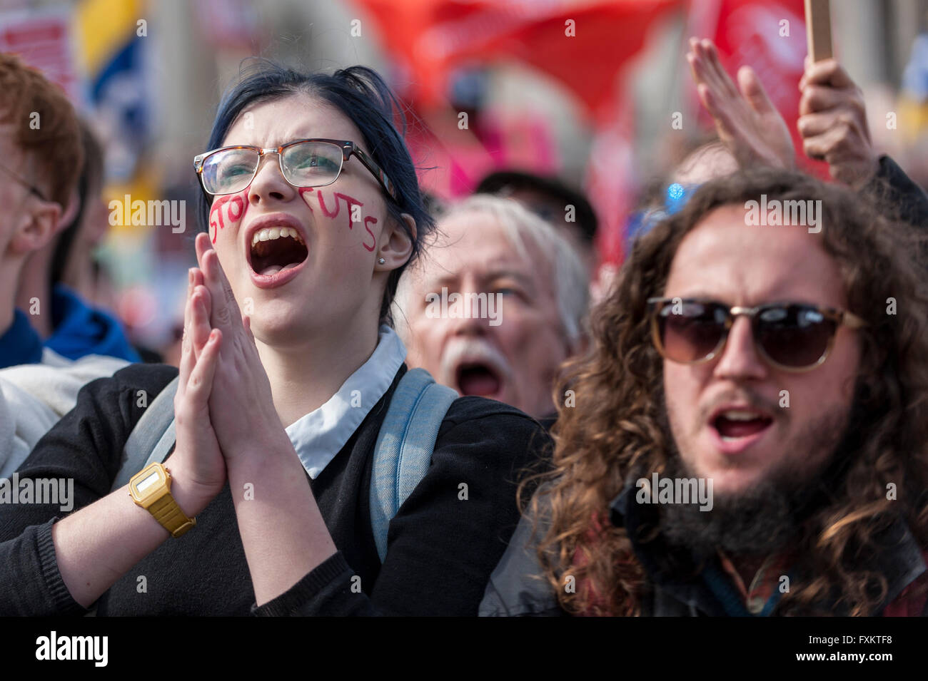 London, UK.  16 April 2016. A girl wears the text Stop Cuts on her arms and face.  Protestors march on Trafalgar Square during The March for Health, Homes, Jobs and Education, organised by the People's Assembly.  Thousands listened to speakers and trade unionists who spoke about anti-austerity, saving the NHS and an end to Tory rule.  Credit:  Stephen Chung / Alamy Live News Stock Photo