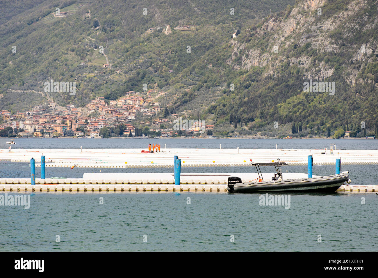 Lake Iseo, Italy. 16th April, 2016. Workers build Christo and Jeanne-Claude's artwork 'The Floating Pier'. Roberto Cerruti/Alamy Live News Stock Photo