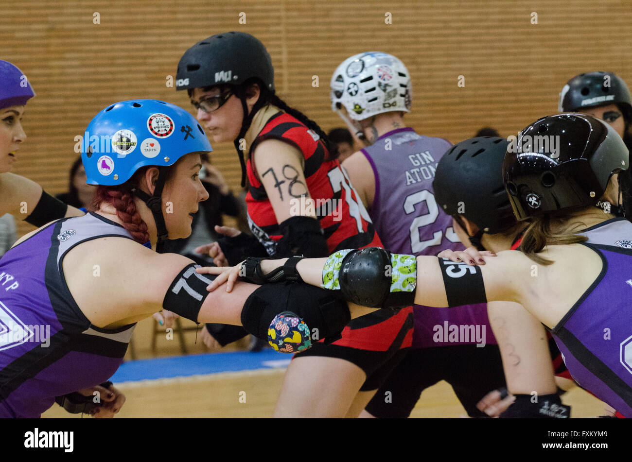 Madrid, Spain. 16th April, 2016. Players of Croydon Roller Derby Vice Squad preparing a defensive position by holding their arms. Credit:  Valentin Sama-Rojo/Alamy Live News. Stock Photo
