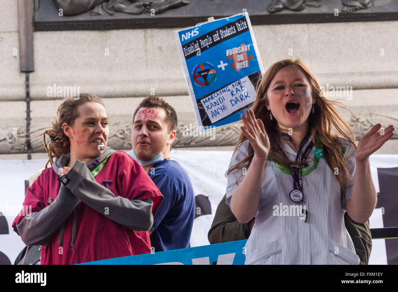 London, UK. 16th April, 2016. Student nurses from the Bursary or Bust campaign including Danielle Tiplady (right) applaud as a junior doctor speaiks  at the Trafalgar Square rally after the Peoples Assembly Against Austerity march demanding an end to privatisation of the NHS, secure homes for all, rent control and an end to attacks on social housing, an end to insecure jobs and the scrapping of the Trade Union Bill, tuition fees and the marketisation of education.  Peter Marshall/Alamy Live News Stock Photo