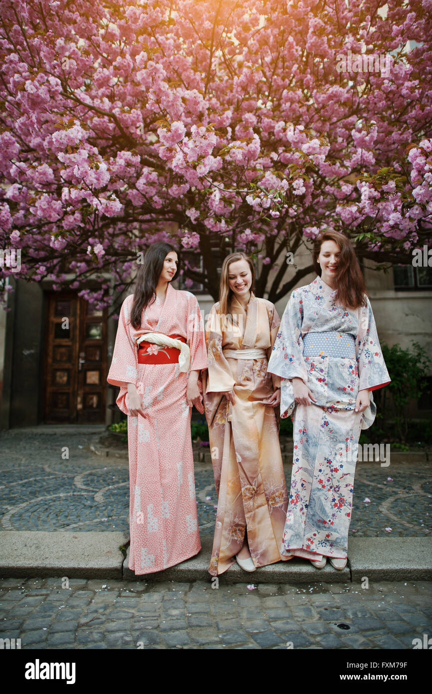 Three european girls wearing traditional japanese kimono background blossom  pink sakura tree Stock Photo - Alamy