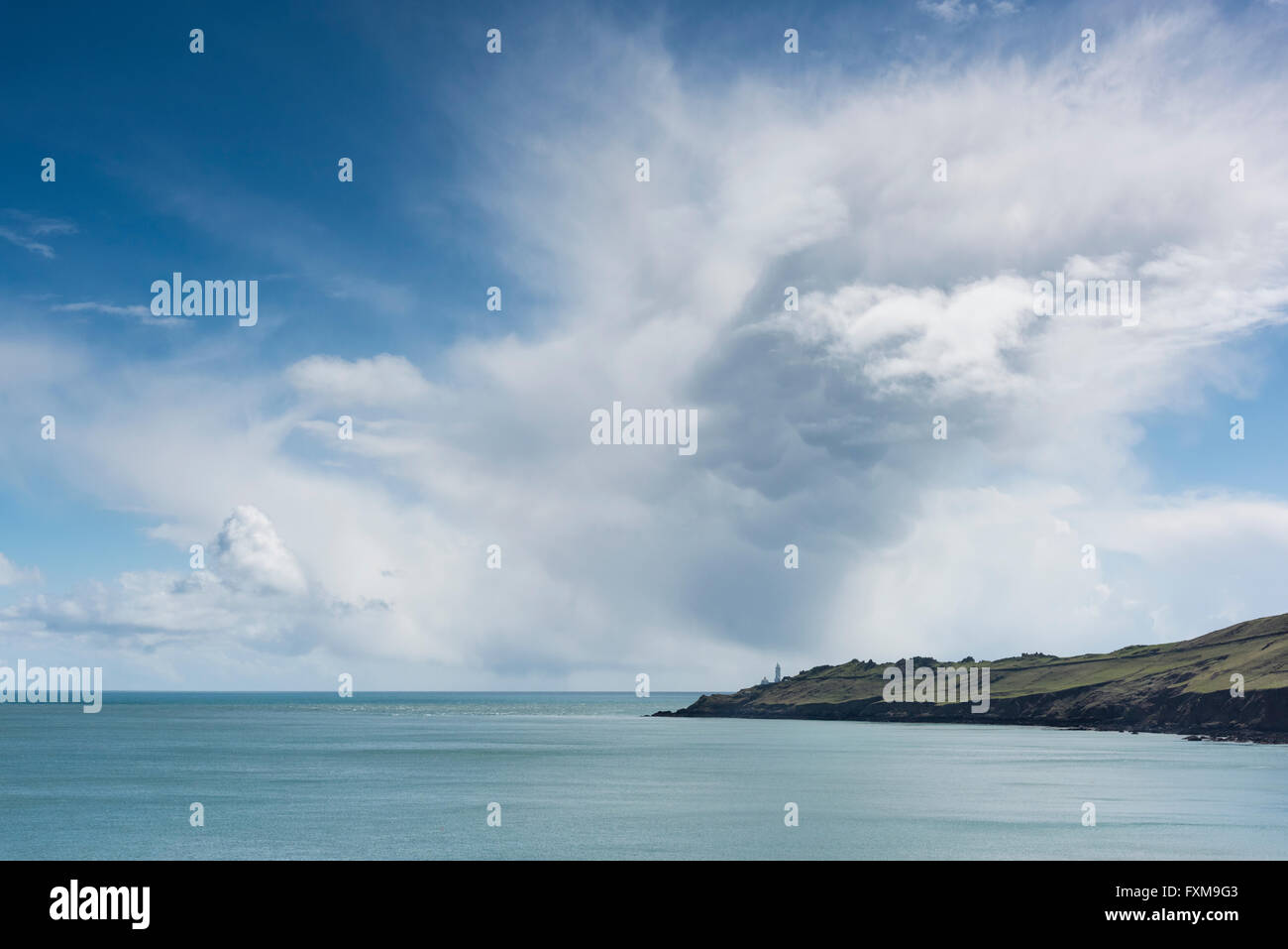A view of Start Point and Start Point Lighthouse on the South Devon Coast UK with large cumulo nimbus cloud Stock Photo