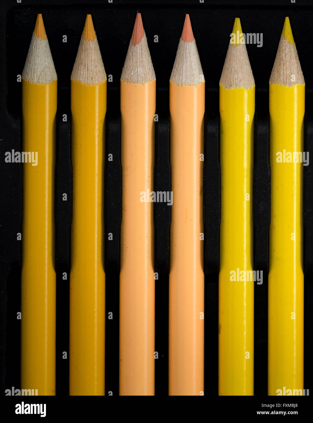 Yellow Colouring Pencils on black background Stock Photo