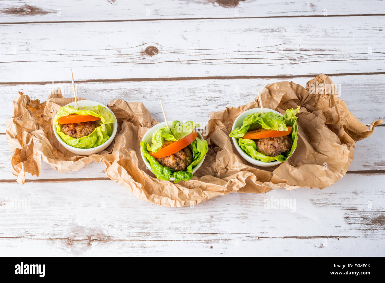 Bunless burger with bun replaced with lettuce leaves Stock Photo