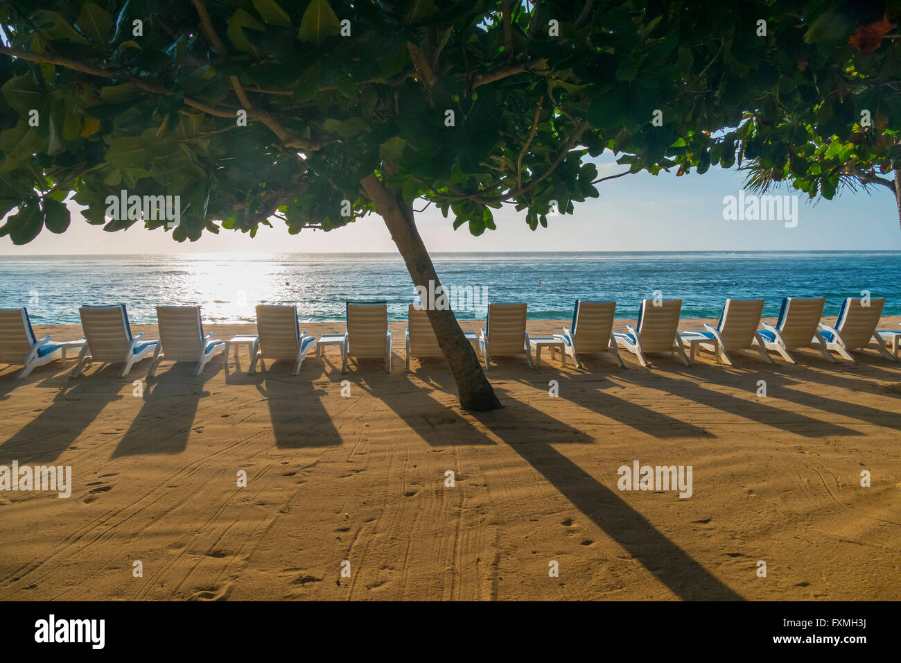 Beach Chairs Line up at Beach in Nusa Dua, Bali, Indonesia Stock Photo