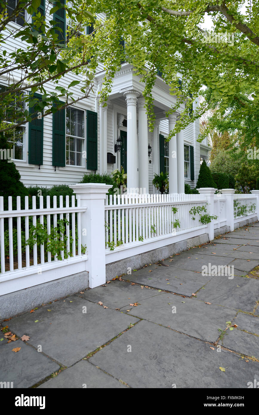 white picket fence by a typical federal style house in Stonington Connecticut Stock Photo