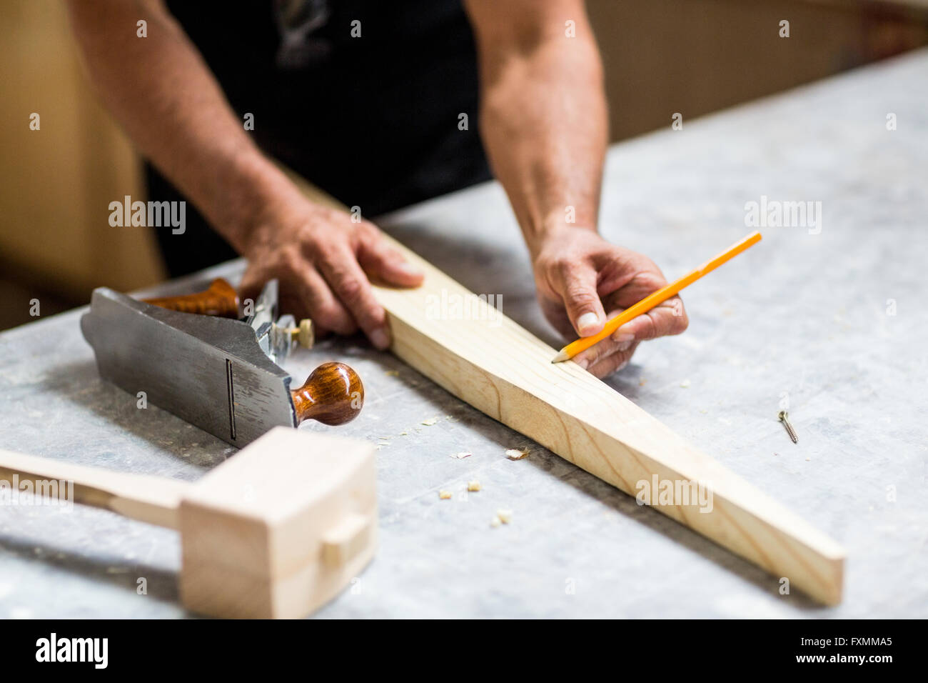 Carpenter marking on wooden plank with pencil Stock Photo Alamy