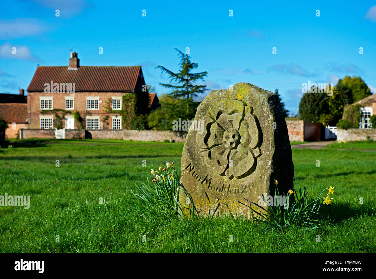 Cottage and millennial stone in the village of Nun Monkton, North