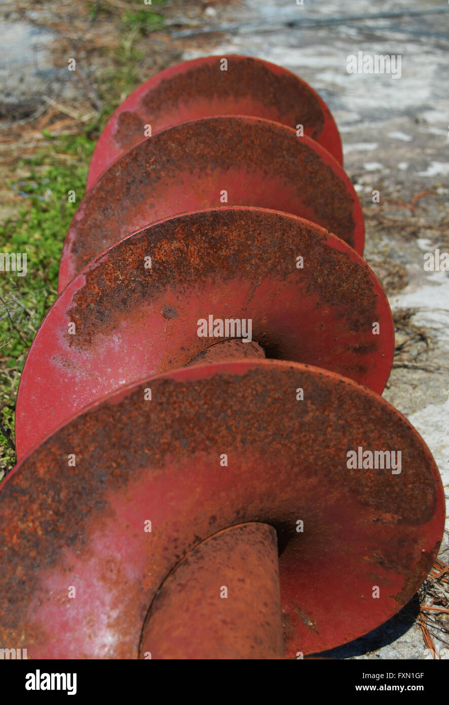 A portrait shot of a auger spiraling on a chipped concrete bed. Stock Photo