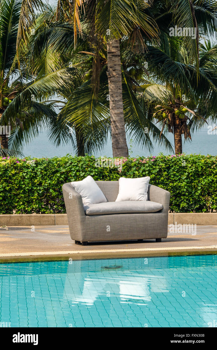 Outdoor indoor sofa chair with cushion and water resistant pillows Stock Photo Alamy