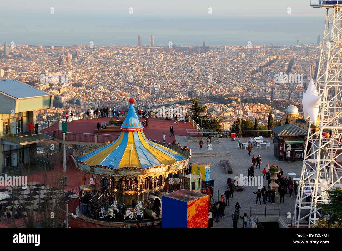 Tibidabo amusement park, with people having fun in the top of the city of Barcelona, Spain Stock Photo