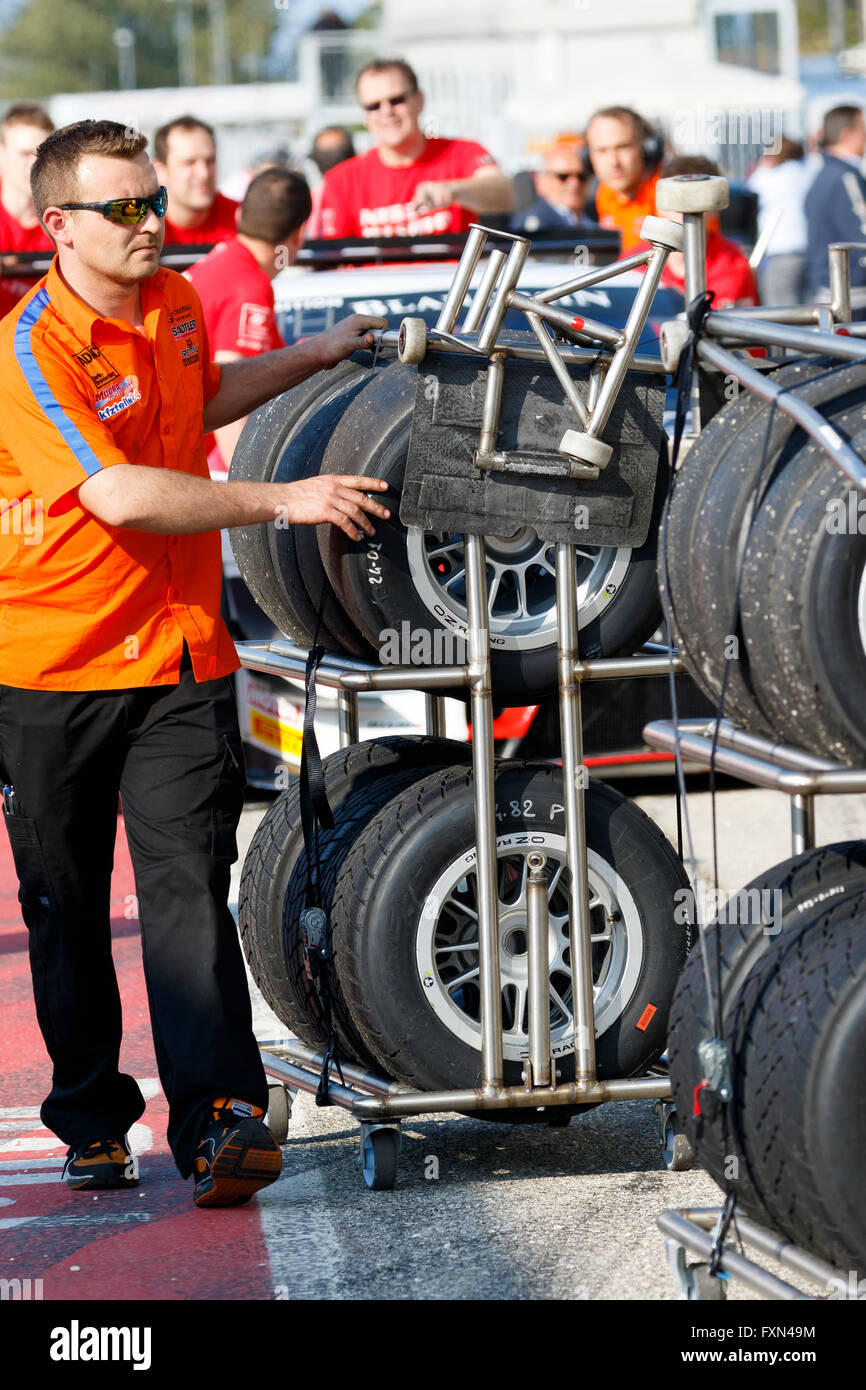 Misano Adriatico, Italy - April 10, 2016:  A man pushes a rack of tyres at the Misano World Circuit, in Misano Adriatico, Italy Stock Photo