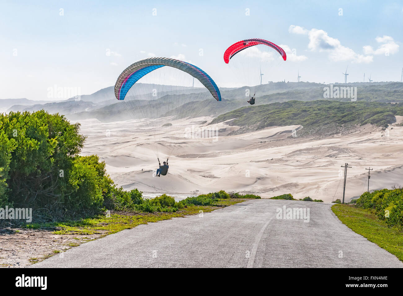 PORT ELIZABETH, SOUTH AFRICA - FEBRUARY 27, 2016: Silhouettes of two  paragliders in the air against beach dunes at Beachview Stock Photo - Alamy