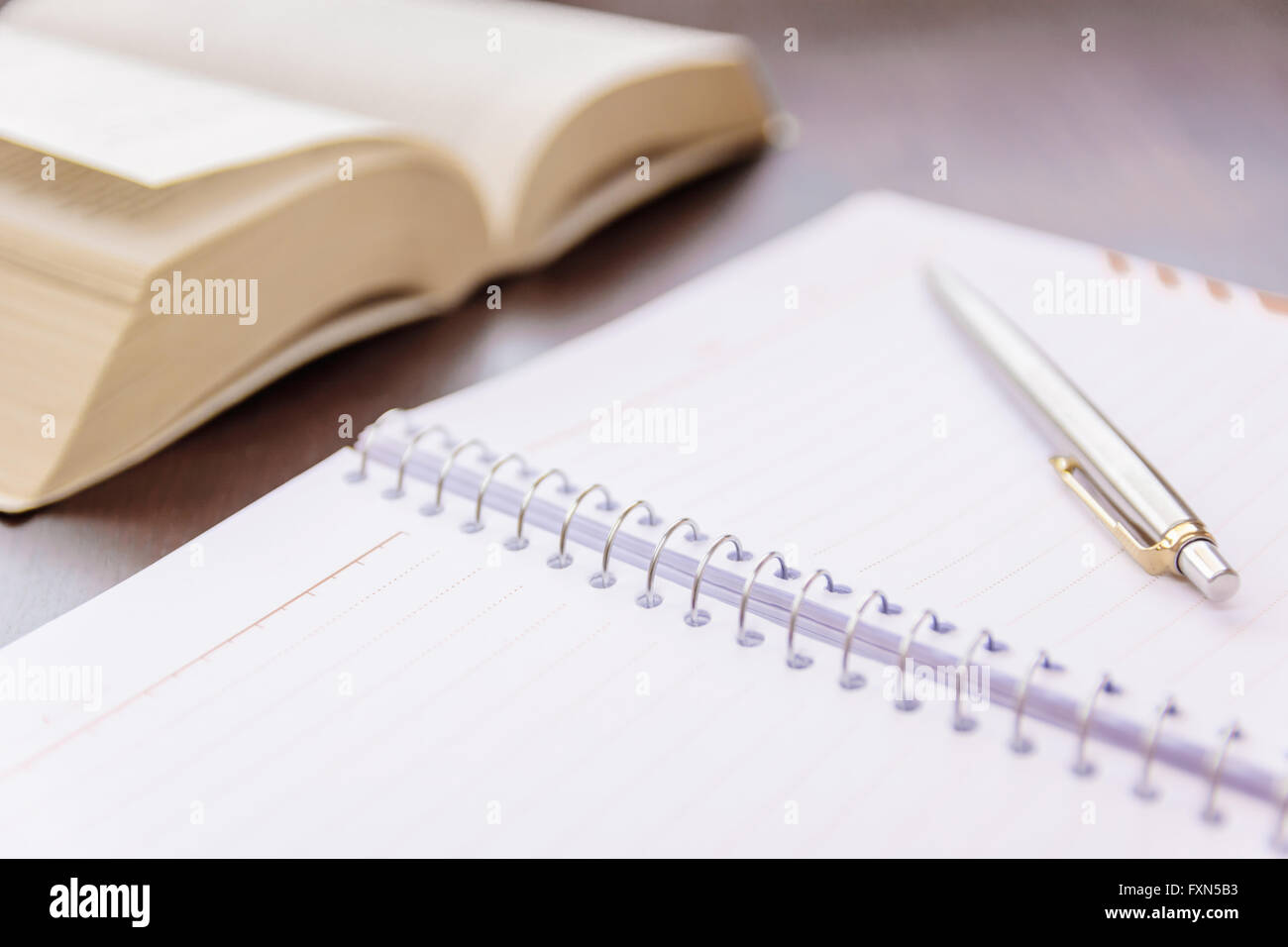 Close-up of open book and pen Stock Photo - Alamy