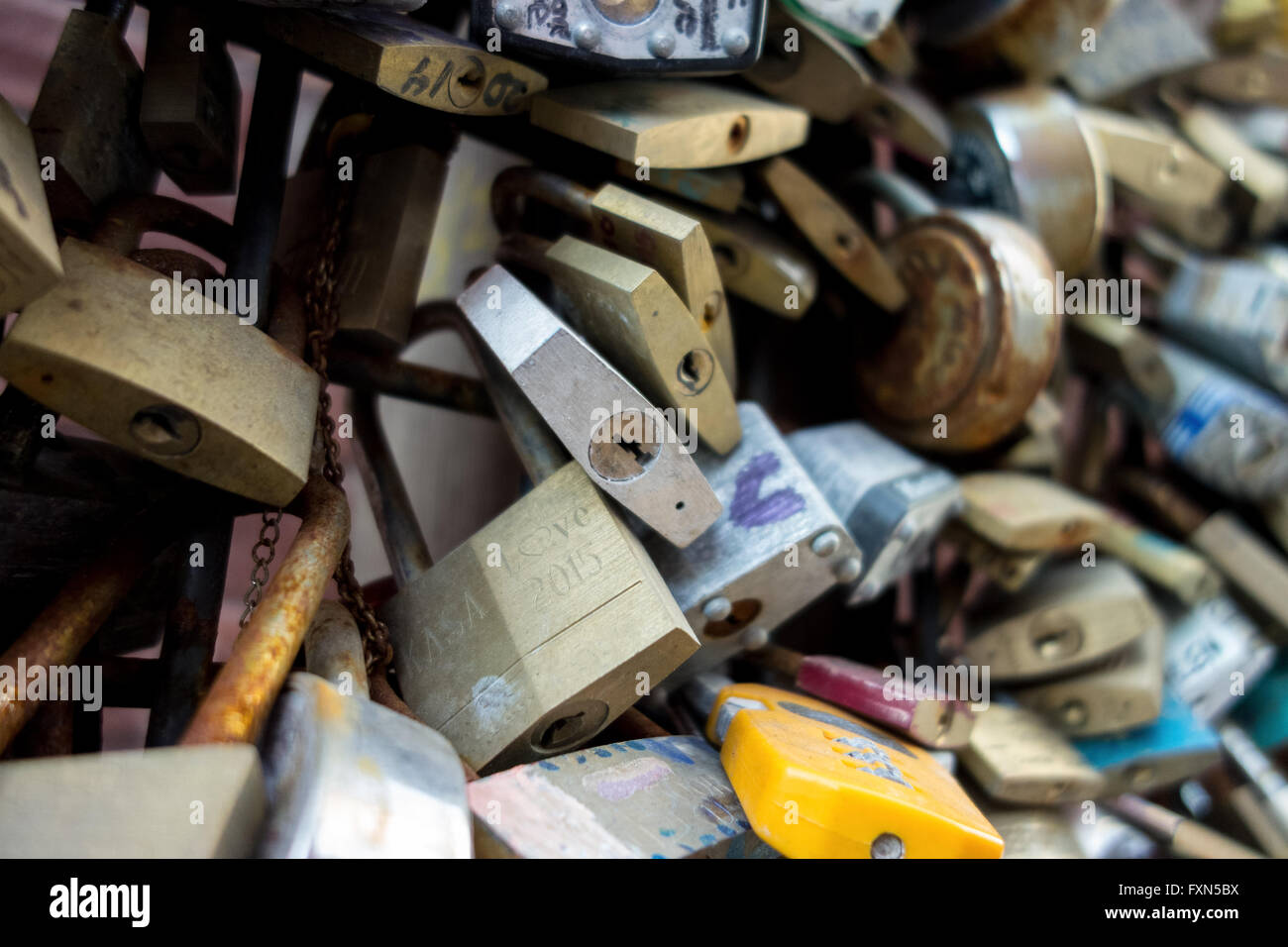 Romance - Love locks on fencing bunched together for love and relationship concept. Note that all logos have been removed. Stock Photo