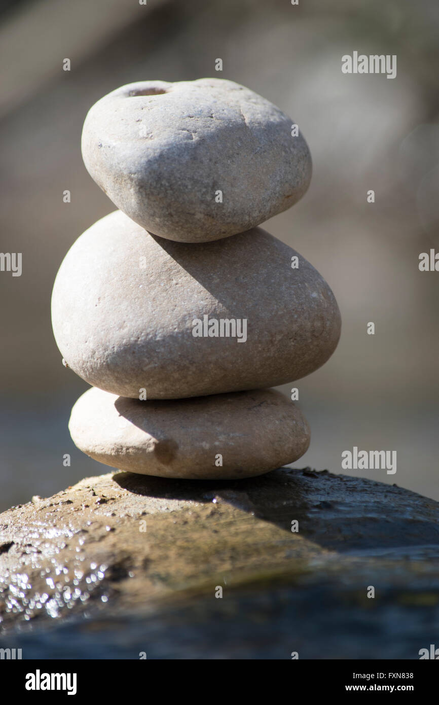 meditation stones sitting on boulder by stream Stock Photo - Alamy
