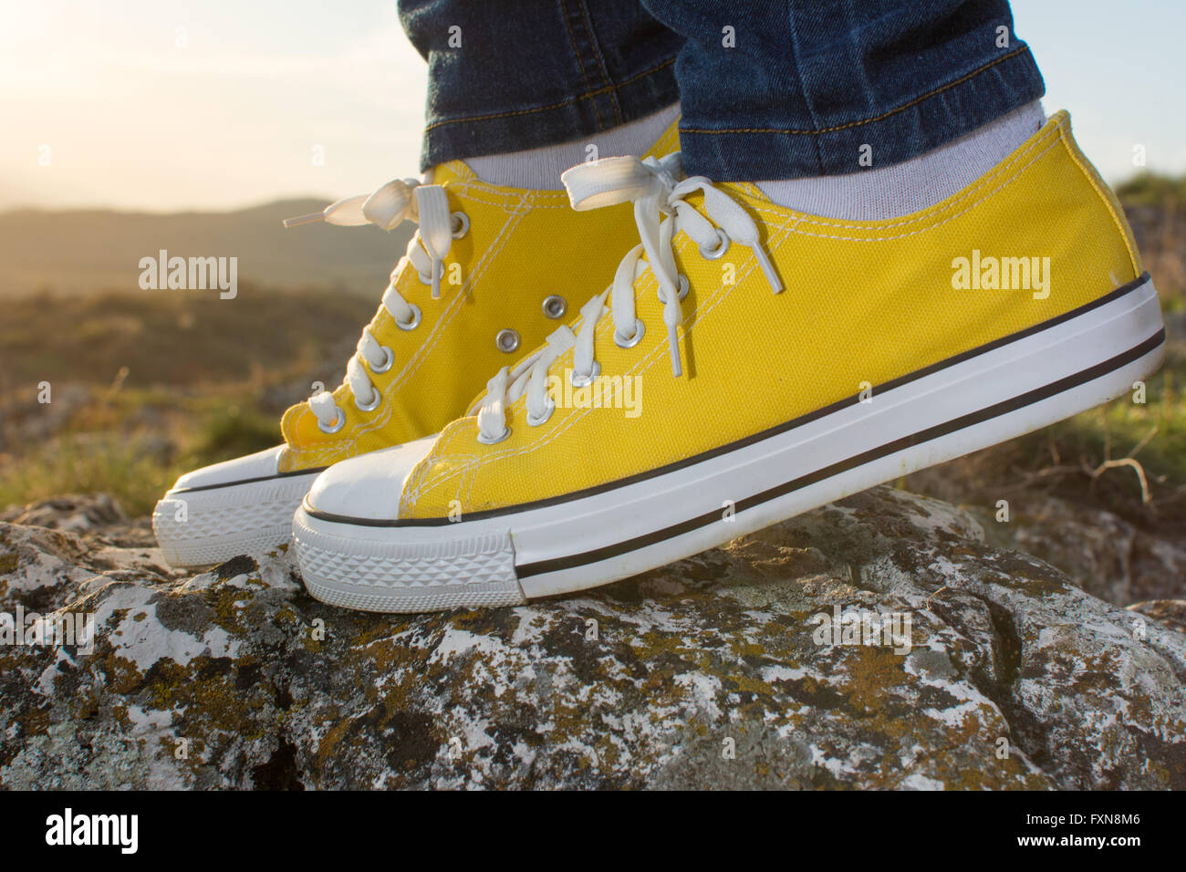 Woman on a hiking trip with close up at yellow sneakers Stock Photo