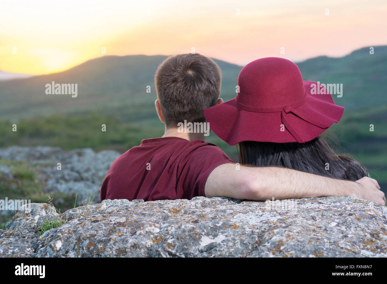 Couple enjoying a romantic sunset on a hiking trip Stock Photo