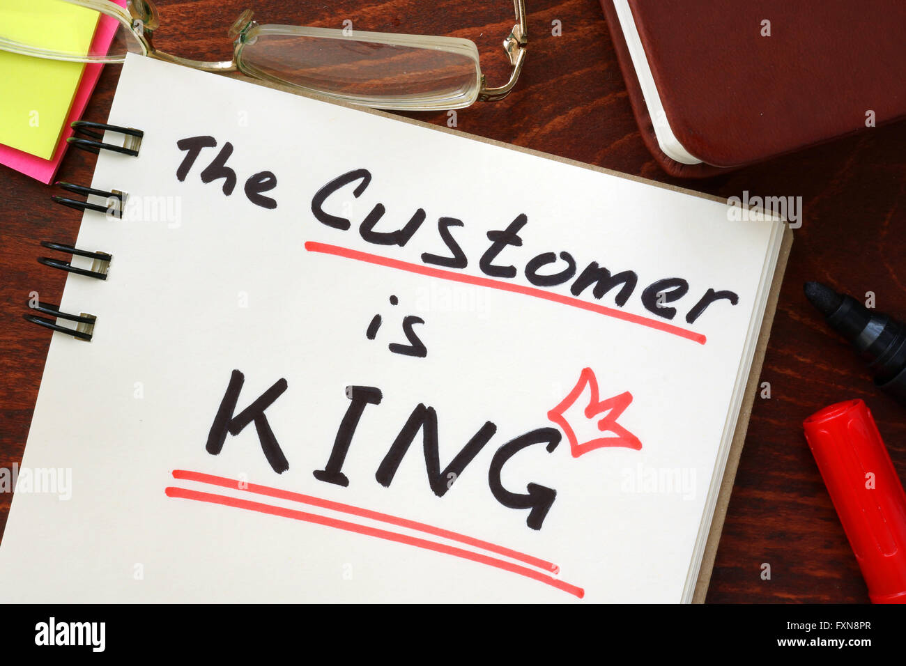 The Customer is King written in a notebook. Marketing concept. Stock Photo