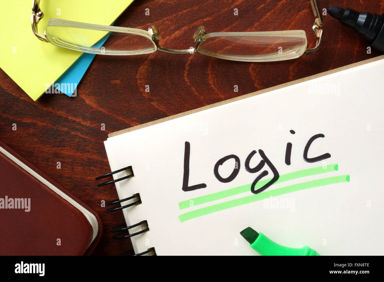 Logic written in a notepad on a wooden background. Stock Photo